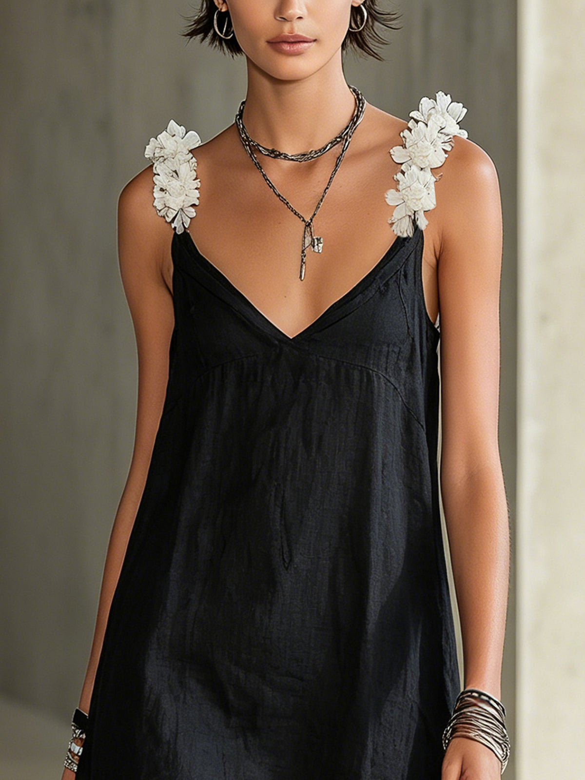 Black mini dress with V-neckline and floral straps